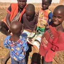 Some kids reading a book we brought!