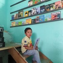 Manuel reading in the library