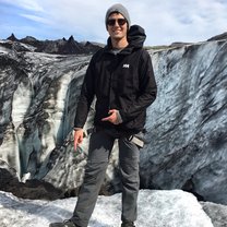 Pointing at the spikes that were tied to my feet during the Glacier Hike.