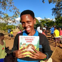 Man smiling with book.