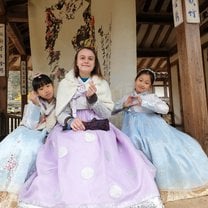 3 girls dressed in hanbok, traditional Korean clothes, sending hearts to the camera