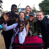 Excited Village Book Builder volunteers smiling together in Kenya.