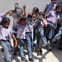 Teaching in India - Volunteer donates new shoes to all the students