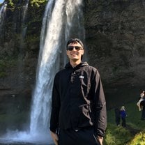 Visiting a beautiful waterfall during a sunny day.