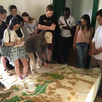 Group receiving a talk over a large landscape model