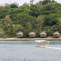 small boat heading the paradise beach