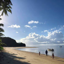 people walking along a palm lined beach