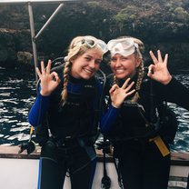 two girls smiling in galapagos about to go scuba diving