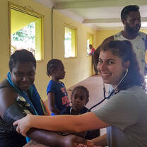 IVI volunteer taking womens blood pressure