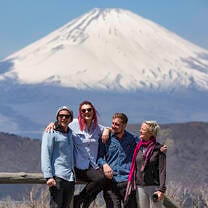 Intro travel tourists pose in front of Mt Fuji views from Hakone