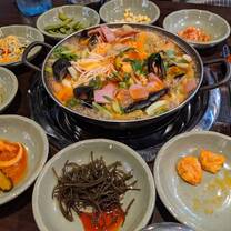 picture of a seafood soup with side dishes