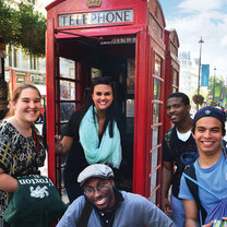 Study abroad students smiling at a phone booth in London