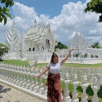 Posing in front of The White Temple, a famous architectural temple in Chaing Rai, Thailand