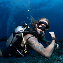 Scuba diver flexing his muscles underwater