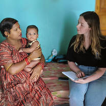 Interviewing a local mother in her home