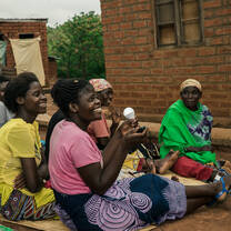 Providing new solar products at a village meeting