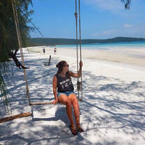 Woman at swing by the beach