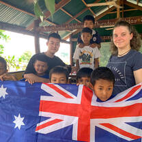Volunteers and kids holding Australian flag