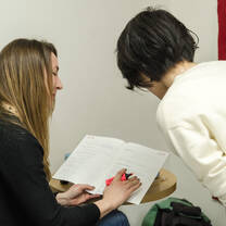 Teacher helping some student