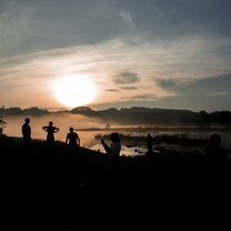 Students hanging out at the Li River at sunset Students sillouettes at sunset by the Li River