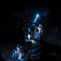 Caving in Yangshuo with Omeida Chinese Academy Cavers explore by torchlight