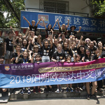 Meet some of our previous students! Students pose for a group photo outside of language school