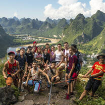 A group photos of students backdropped by Yangshuo landscape