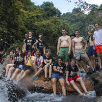 A group photo of students by a river
