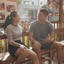 Language exchange - find a native speaking language partner to practise your Chinese! A girl and boy talking on a bench