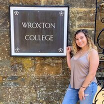 Me outside the abbey gates in front of the college sign