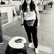 Standing outside the departure area at the airport with my luggage and my IVHQ volunteer shirt prior to boarding my flight.