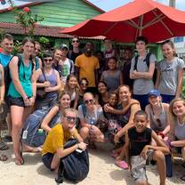 This is a group shot after eating our lionfish meal made by Leny and aided by us!! We also made bags, necklaces, and bracelet for Leny and her family to sell!!