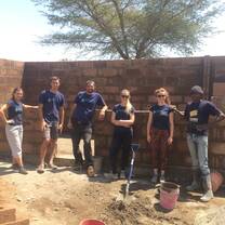 Volunteers working with locals to build a chicken coop