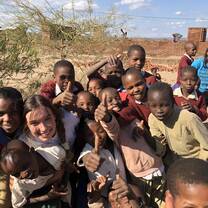 me with a group of kids smiling with their whole hearts