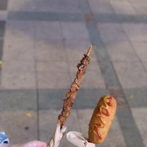 A Korean corn dog and meat skewer. They can be found and bought on the street by vendors.