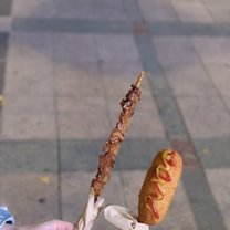 A Korean corn dog and meat skewer. They can be found and bought on the street by vendors.