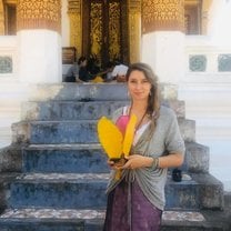 Standing outside of a temple with a handmade lantern.