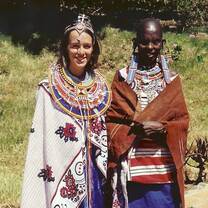 Participant in local dress with a woman from Kenya