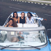 Semester students getting a ride in vintage car