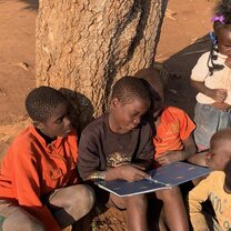 Reading together under a tree