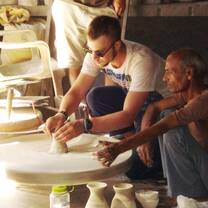 Participant learns how to make pottery on traditional wheel