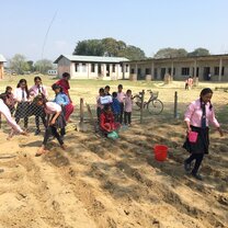 Students learning key farming skills in the vegatable patch that was built by volunteers Projects Abroad Nepal