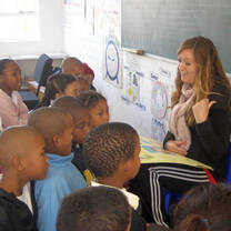 woman teaching to children.