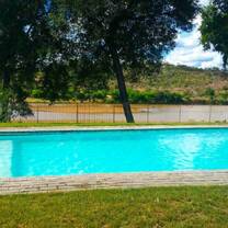 Onsite camp amenities including a pool, communal areas, bar area and viewing decks
