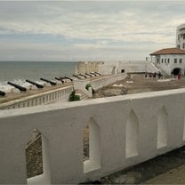 Looking back at the cape coast slave castle and out to sea. Untold numbers of slaves passed through or died in the dungeons below the brick yard.  