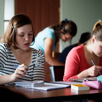 students sitting at a desk reading