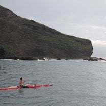 Paddling an outrigger canoe off the coast of Nuku Hiva, Marquesas Islands