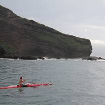 Paddling an outrigger canoe off the coast of Nuku Hiva, Marquesas Islands