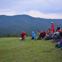 Mongolia Field School 2019 participants gather by the Eg River Science Camp as the course leader briefs them