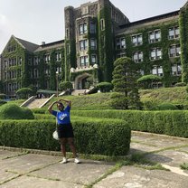 Girl in front of ivy covered school building at Yonsei Univerity